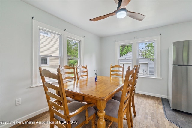 5104 Old Lansing Rd, Lansing, MI 48917 - dining room with light wood-style floors, a ceiling fan, and baseboards