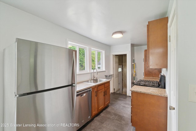 5104 Old Lansing Rd, Lansing, MI 48917 - kitchen featuring appliances with stainless steel finishes, a sink, light countertops, and brown cabinets