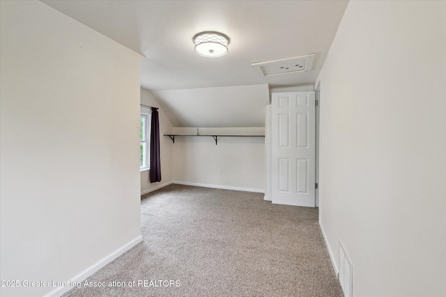 5104 Old Lansing Rd, Lansing, MI 48917 - additional living space featuring carpet, baseboards, vaulted ceiling, and attic access