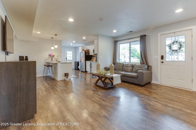 4614 Addison Rd, Lansing, MI 48917 - living room featuring wood finished floors, recessed lighting, and baseboards