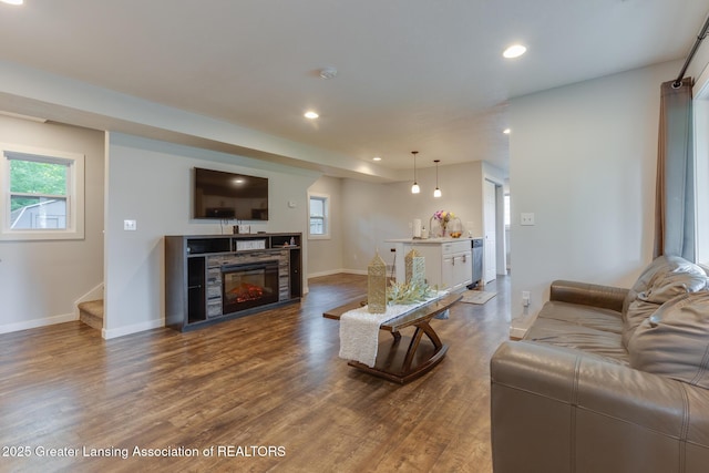 4614 Addison Rd, Lansing, MI 48917 - living room with stairs, healthy amount of natural light, recessed lighting, and dark wood finished floors