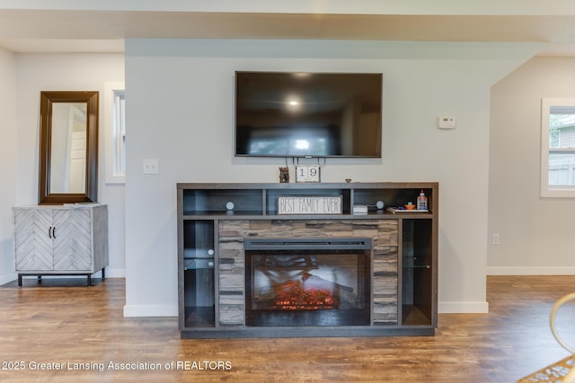 4614 Addison Rd, Lansing, MI 48917 - living room with wood finished floors, baseboards, and a glass covered fireplace