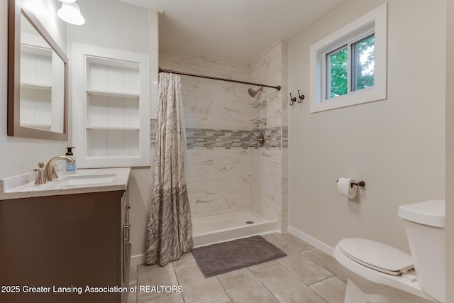 4614 Addison Rd, Lansing, MI 48917 - bathroom featuring toilet, vanity, a tile shower, and tile patterned flooring