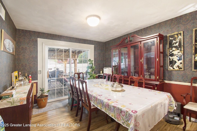 3733 Colchester Rd, Lansing, MI 48906 - dining area with wallpapered walls and wood finished floors