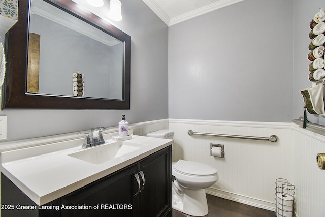 3733 Colchester Rd, Lansing, MI 48906 - bathroom with vanity, wainscoting, crown molding, toilet, and wood finished floors
