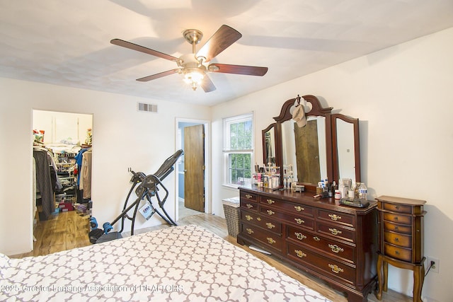 3733 Colchester Rd, Lansing, MI 48906 - bedroom with a spacious closet, light wood finished floors, a closet, and a ceiling fan