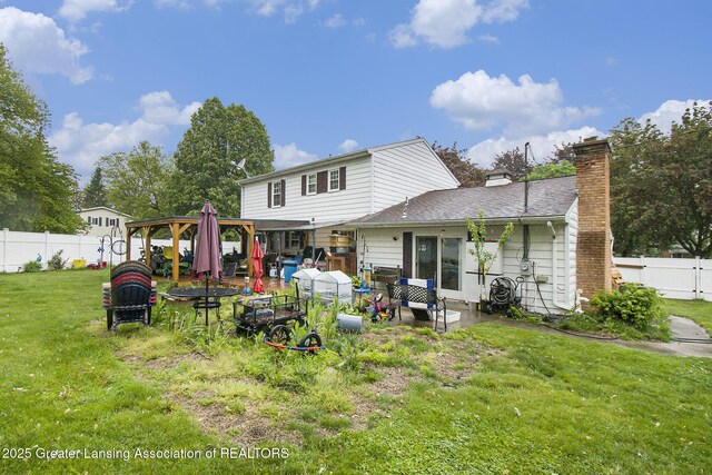 3733 Colchester Rd, Lansing, MI 48906 - back of house featuring a gazebo, a chimney, and a patio