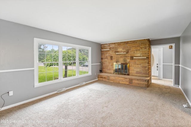 1111 Battle Creek Rd, Charlotte, MI 48813 - unfurnished living room featuring a large fireplace, carpet flooring, and baseboards
