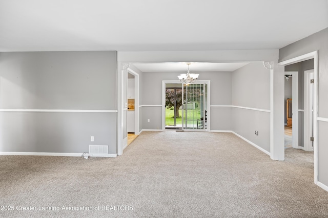1111 Battle Creek Rd, Charlotte, MI 48813 - empty room featuring a chandelier, carpet floors, and baseboards