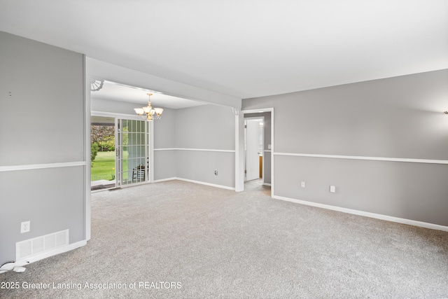 1111 Battle Creek Rd, Charlotte, MI 48813 - unfurnished room featuring a chandelier, carpet, and baseboards
