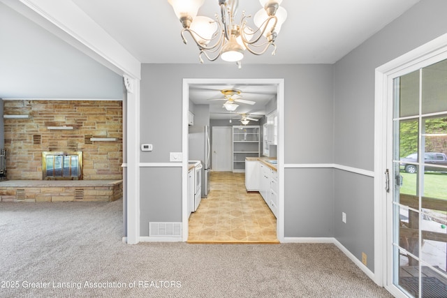 1111 Battle Creek Rd, Charlotte, MI 48813 - unfurnished dining area featuring a chandelier, light carpet, ceiling fan, and baseboards