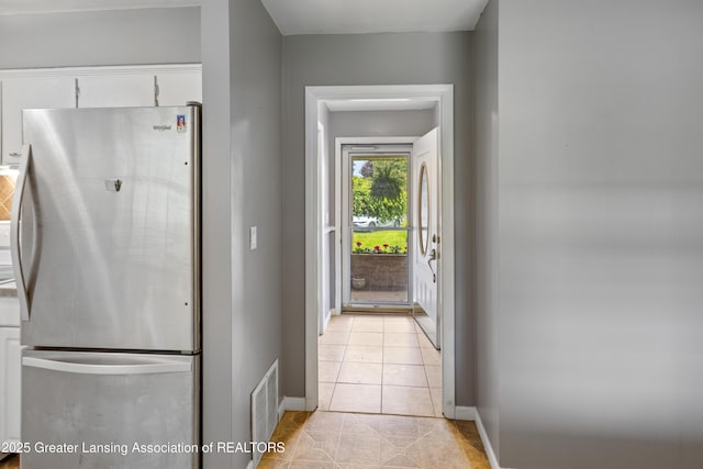 1111 Battle Creek Rd, Charlotte, MI 48813 - doorway featuring baseboards and light tile patterned flooring