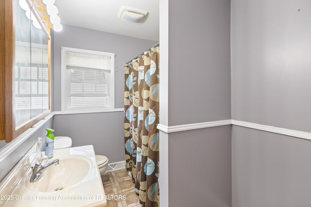 1111 Battle Creek Rd, Charlotte, MI 48813 - bathroom featuring toilet, healthy amount of natural light, vanity, and baseboards
