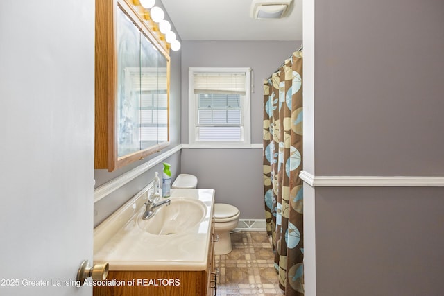 1111 Battle Creek Rd, Charlotte, MI 48813 - full bathroom with vanity, toilet, and baseboards