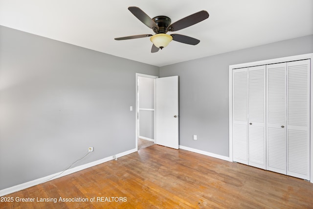 1111 Battle Creek Rd, Charlotte, MI 48813 - unfurnished bedroom featuring a closet, baseboards, light wood-type flooring, and a ceiling fan