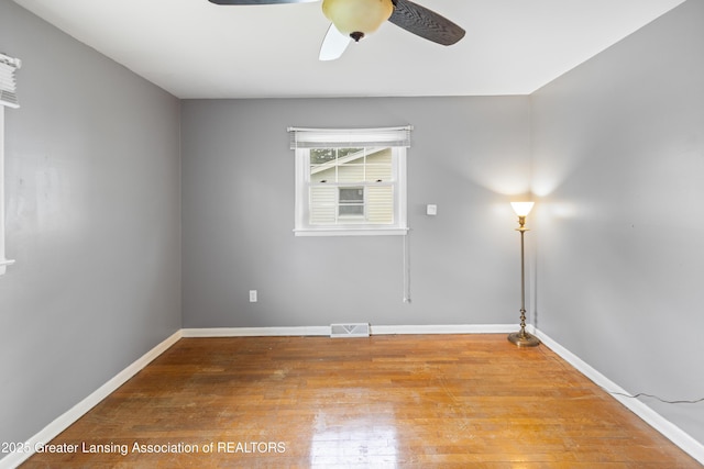 1111 Battle Creek Rd, Charlotte, MI 48813 - spare room featuring a ceiling fan, wood finished floors, and baseboards