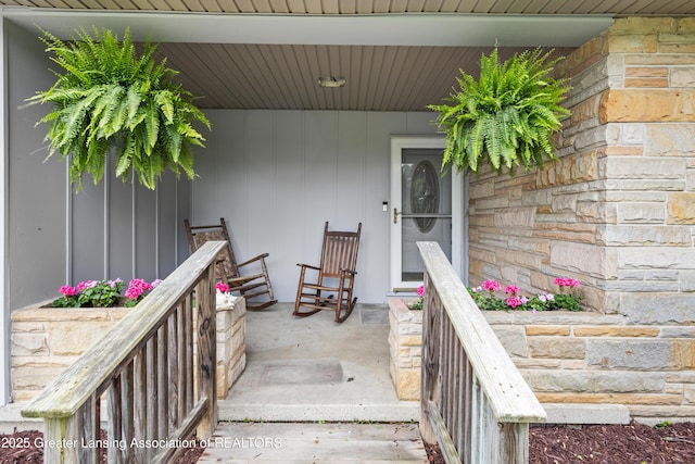 1111 Battle Creek Rd, Charlotte, MI 48813 - doorway to property featuring stone siding and covered porch