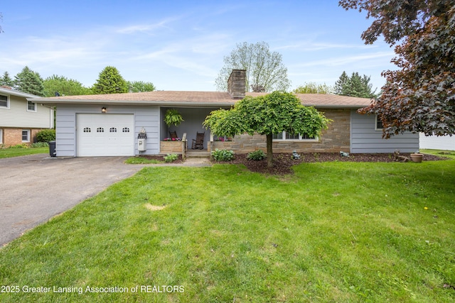 1111 Battle Creek Rd, Charlotte, MI 48813 - view of front of property with a chimney, a front lawn, an attached garage, and asphalt driveway