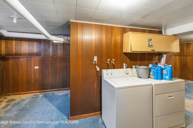 1111 Battle Creek Rd, Charlotte, MI 48813 - washroom with wooden walls, separate washer and dryer, and cabinet space