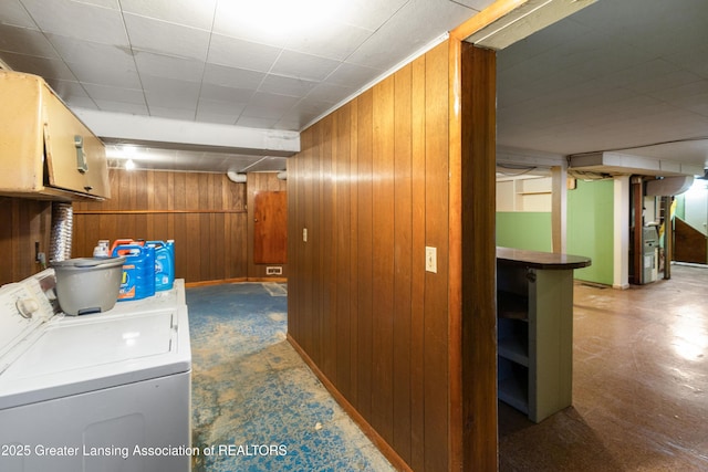 1111 Battle Creek Rd, Charlotte, MI 48813 - washroom with washer and dryer, cabinet space, and wooden walls