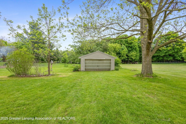 1111 Battle Creek Rd, Charlotte, MI 48813 - view of green lawn featuring an outdoor structure and a detached garage