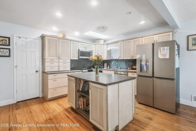 1435 Epley Rd, Williamston, MI 48895 - kitchen featuring appliances with stainless steel finishes, tasteful backsplash, dark countertops, light wood-style floors, and recessed lighting