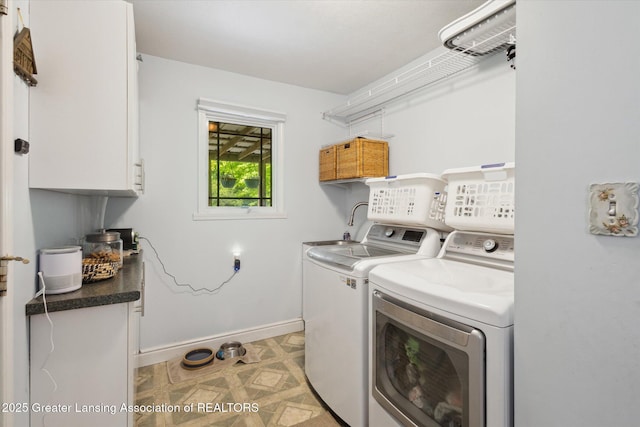 1435 Epley Rd, Williamston, MI 48895 - laundry room featuring cabinet space, separate washer and dryer, and baseboards