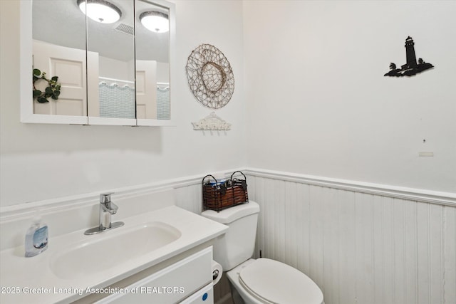 1435 Epley Rd, Williamston, MI 48895 - full bathroom featuring a wainscoted wall, toilet, and vanity