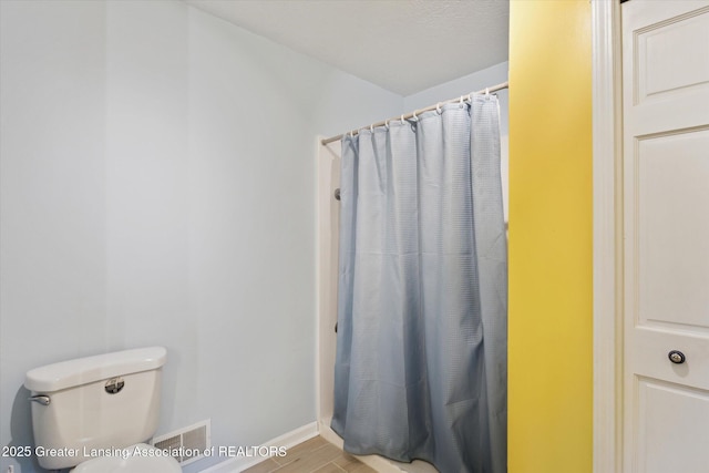 1435 Epley Rd, Williamston, MI 48895 - bathroom with toilet, curtained shower, baseboards, and wood finished floors