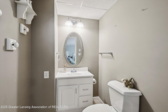1435 Epley Rd, Williamston, MI 48895 - half bath with a paneled ceiling, toilet, vanity, and baseboards
