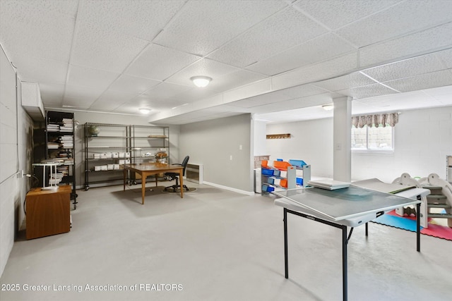 1435 Epley Rd, Williamston, MI 48895 - rec room with finished concrete floors, a paneled ceiling, and concrete block wall