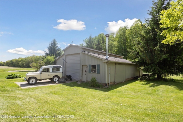 1435 Epley Rd, Williamston, MI 48895 - view of side of home with an outdoor structure, a yard, and a detached garage