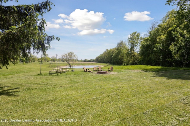 1435 Epley Rd, Williamston, MI 48895 - view of grassy yard with a fire pit and a water view