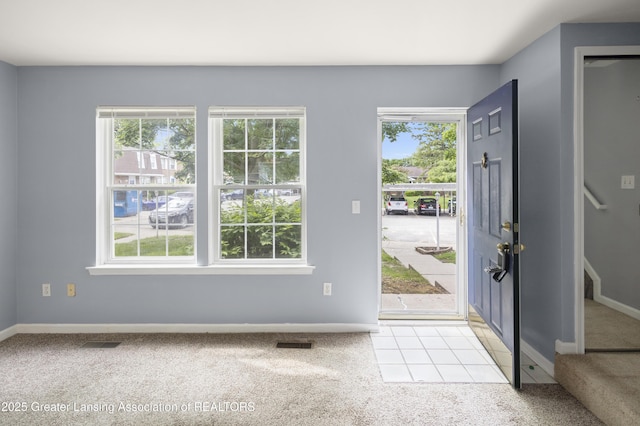 6215 Beechfield Dr, Lansing, MI 48911 - foyer featuring light colored carpet, plenty of natural light, and baseboards