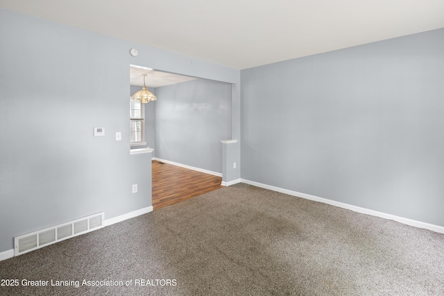 6215 Beechfield Dr, Lansing, MI 48911 - carpeted spare room featuring a chandelier and baseboards