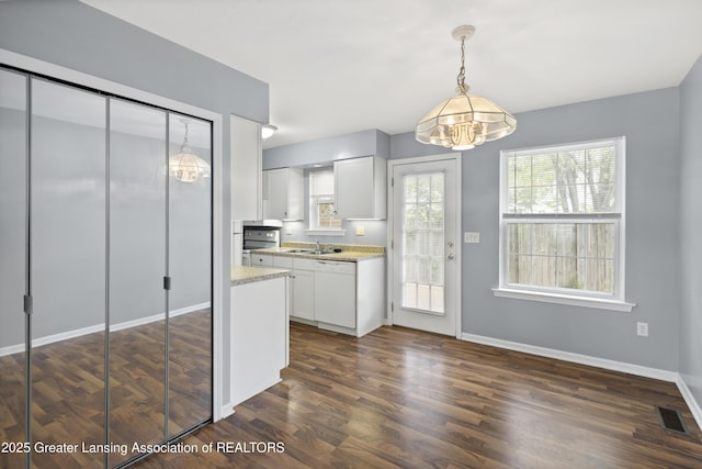 6215 Beechfield Dr, Lansing, MI 48911 - kitchen featuring a chandelier, white cabinets, dark wood-style flooring, and hanging light fixtures