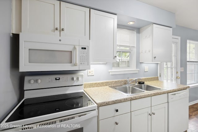 6215 Beechfield Dr, Lansing, MI 48911 - kitchen featuring white appliances, a sink, white cabinetry, and light countertops