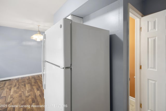 6215 Beechfield Dr, Lansing, MI 48911 - kitchen featuring freestanding refrigerator, wood finished floors, baseboards, and pendant lighting