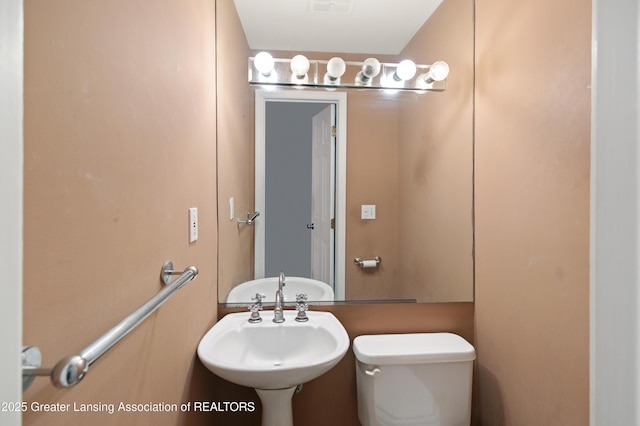 6215 Beechfield Dr, Lansing, MI 48911 - bathroom featuring toilet and a sink