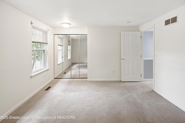 6215 Beechfield Dr, Lansing, MI 48911 - unfurnished bedroom featuring carpet flooring, a closet, and baseboards