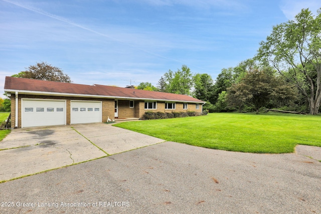 847 N Waverly Rd, Dimondale, MI 48821 - ranch-style home with an attached garage, concrete driveway, a front yard, and brick siding