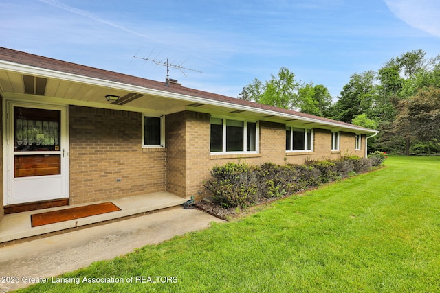 847 N Waverly Rd, Dimondale, MI 48821 - view of side of property with a lawn and brick siding