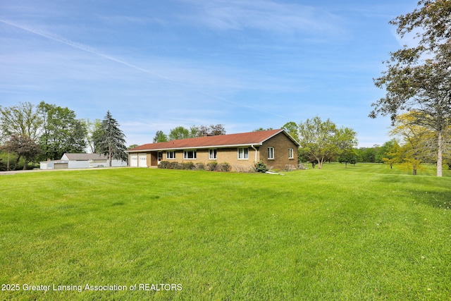 847 N Waverly Rd, Dimondale, MI 48821 - view of front of property with a front lawn, a garage, and brick siding