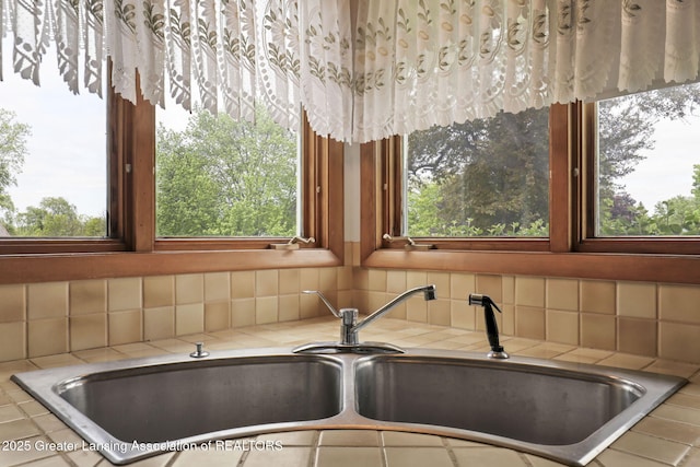 847 N Waverly Rd, Dimondale, MI 48821 - kitchen view of tile countertops, a sink, and backsplash
