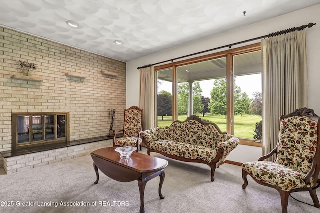 847 N Waverly Rd, Dimondale, MI 48821 - living area with carpet flooring, brick wall, a fireplace, and recessed lighting