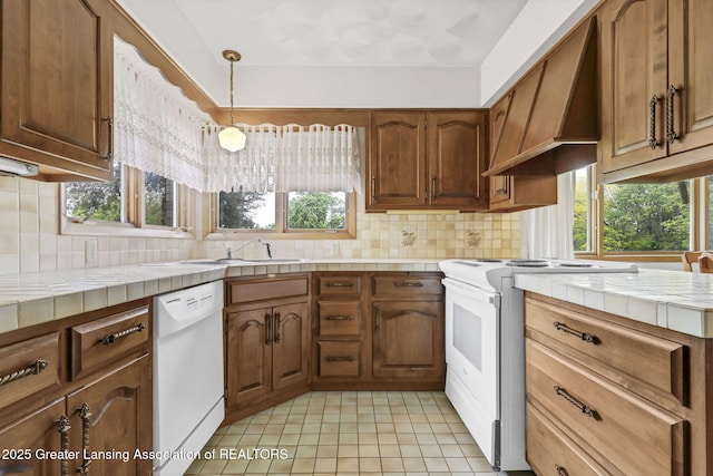 847 N Waverly Rd, Dimondale, MI 48821 - kitchen featuring white appliances, tile countertops, custom exhaust hood, and plenty of natural light