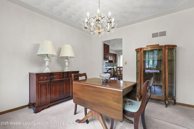847 N Waverly Rd, Dimondale, MI 48821 - dining room with light colored carpet, a chandelier, and baseboards