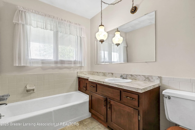 847 N Waverly Rd, Dimondale, MI 48821 - full bath featuring a bath, vanity, toilet, tile patterned flooring, and wainscoting