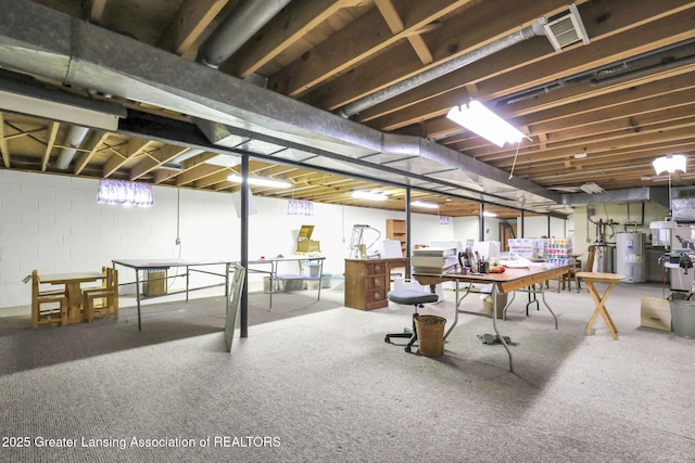 847 N Waverly Rd, Dimondale, MI 48821 - unfinished basement with electric water heater, a desk, concrete block wall, and carpet flooring