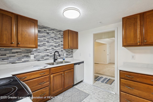 1900 Kaplan St, Lansing, MI 48917 - kitchen featuring dishwasher, a sink, light countertops, decorative backsplash, and a textured ceiling